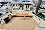 MJM 50z - Spacious deck of 2017 MJM 50z yacht with cushioned seating and wooden table.