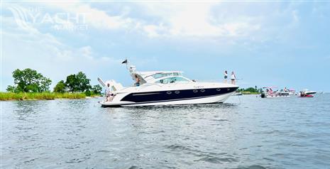 Fairline Targa 52 GT - 2003 Fairline Targa 52 GT yacht on calm water with people onboard.