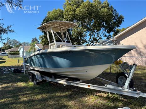 Scout 215 XSF - 2018 Scout 215 XSF boat on trailer, parked in a residential yard.