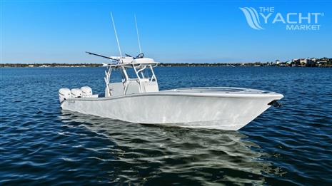 Yellowfin 36 Offshore - 2016 Yellowfin 36 Offshore boat on calm water under clear blue sky.