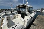 Boston Whaler 325 Conquest Pilothouse - 2020 Boston Whaler 325 Conquest Pilothouse docked at marina, clear sky background.