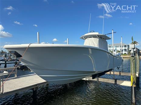 Yellowfin 36 Offshore - 2016 Yellowfin 36 Offshore boat docked at marina under clear blue sky.