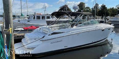 Cobalt 323 - 2007 Cobalt 323 boat docked at a marina with other boats.