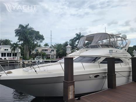 Sea Ray 450 Express Bridge - 2001 Sea Ray 450 Express Bridge yacht docked by waterfront homes.