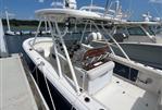 Pursuit S 280 Sport - 2011 Pursuit S 280 Sport boat docked at marina under blue sky.