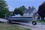 Axopar 28 T-Top - 2023 Axopar 28 T-Top boat on trailer in suburban neighborhood.