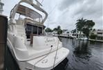 Sea Ray 450 Express Bridge - 2001 Sea Ray 450 Express Bridge yacht docked by waterfront homes.