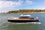 Boston Boatworks Daychaser 48 - 2024 Boston Boatworks Daychaser 48 cruising on a scenic waterway.