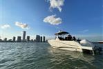 Jeanneau Leader 9.0 CC - 2023 Jeanneau Leader 9.0 CC boat on water with city skyline in background.