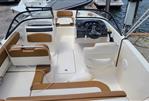 Bayliner VR5 Bowrider OB - 2019 Bayliner VR5 Bowrider OB interior with tan seating and steering console.