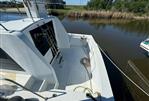 Blue Water Motor Yacht - 1982 Blue Water Motor Yacht docked by a calm riverbank.