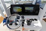 Sea Hunt 265 ultra - 2022 Sea Hunt Ultra 265 SE boat dashboard with dual navigation screens and steering wheel.