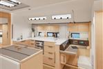 Hanse 510 - Modern kitchen interior of 2023 Hanse 510 yacht with light wood cabinetry and sleek design.