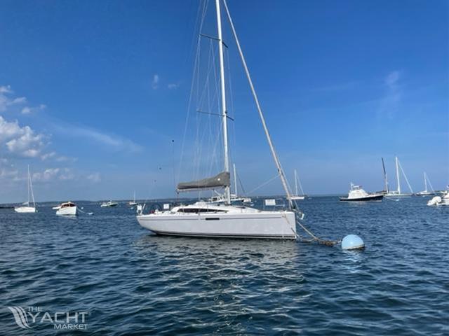 Dehler 34 - 2022 Dehler 34 sailboat anchored in a calm sea with other boats in the background.