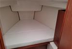 Hanse 315 - 2023 Hanse 315 yacht interior cabin with bed and wooden accents
