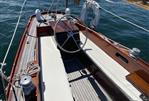 Hinckley Southwest 34 - 1948 Hinckley Southwest 34 sailboat cockpit with wooden trim and steering wheel.