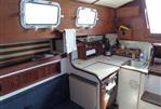 Endeavour 32 - 1979 Endeavour 32 sailboat interior with wooden cabinetry and compact kitchen.