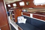 Endeavour 32 - Interior of 1979 Endeavour 32 sailboat with wooden finishes and blue seating.