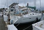 Beneteau 393 - 2003 Beneteau 393 sailboat docked at a marina on a cloudy day.