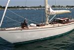JFA Yachts Custom 70 - JFA Yachts Custom 70, 2003 model, sailing on calm waters with a scenic background.