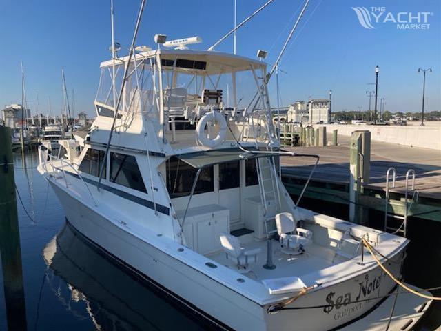 Viking Convertible - 1987 Viking Convertible yacht docked at marina.