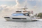 Prestige 690 - 2025 Prestige 690 yacht cruising on calm waters with a scenic background.