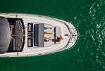 Prestige 690 - Aerial view of 2025 Prestige 690 yacht with people sunbathing on deck.