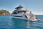 Prestige X70 - Prestige X70 2025 luxury yacht cruising in clear blue waters.
