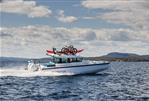 Axopar 37 Cross Cabin XC - 2024 Axopar 37 Cross Cabin XC cruising on open water with kayaks and bikes on roof.