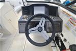 Bayliner VR5 - 2022 Bayliner VR5 boat dashboard with steering wheel and control panel.