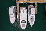 Prestige 520S - Aerial view of a 2020 Prestige 520 S yacht docked between two other boats.
