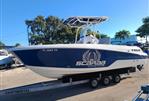 Wellcraft 242 Fisherman - 2023 Wellcraft 242 Fisherman boat on trailer, blue and white, Scarab Offshore branding.