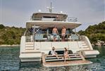 Prestige M8 - People enjoying leisure time on a 2025 Prestige M8 yacht in a scenic bay.