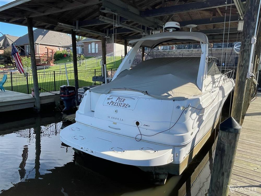 Sea Ray 340 Sundancer - 2002 Sea Ray 340 Sundancer docked under a covered slip.