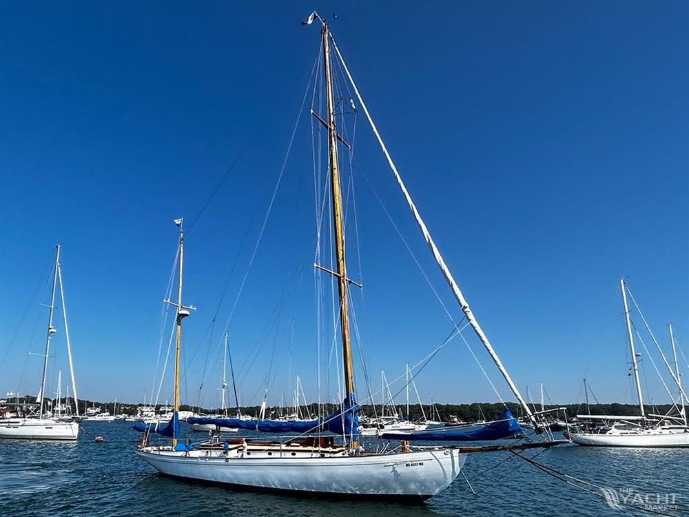 Crocker Yawl - 1930 Crocker Yawl sailboat anchored in a marina on a clear day.