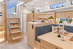 Hanse 410 - Modern interior of 2024 Hanse 410 yacht with light wood finishes and cozy dining area.