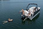 Harris 250 Sunliner Sport - 2023 Harris 250 Sunliner Sport pontoon boat with people enjoying water activities.
