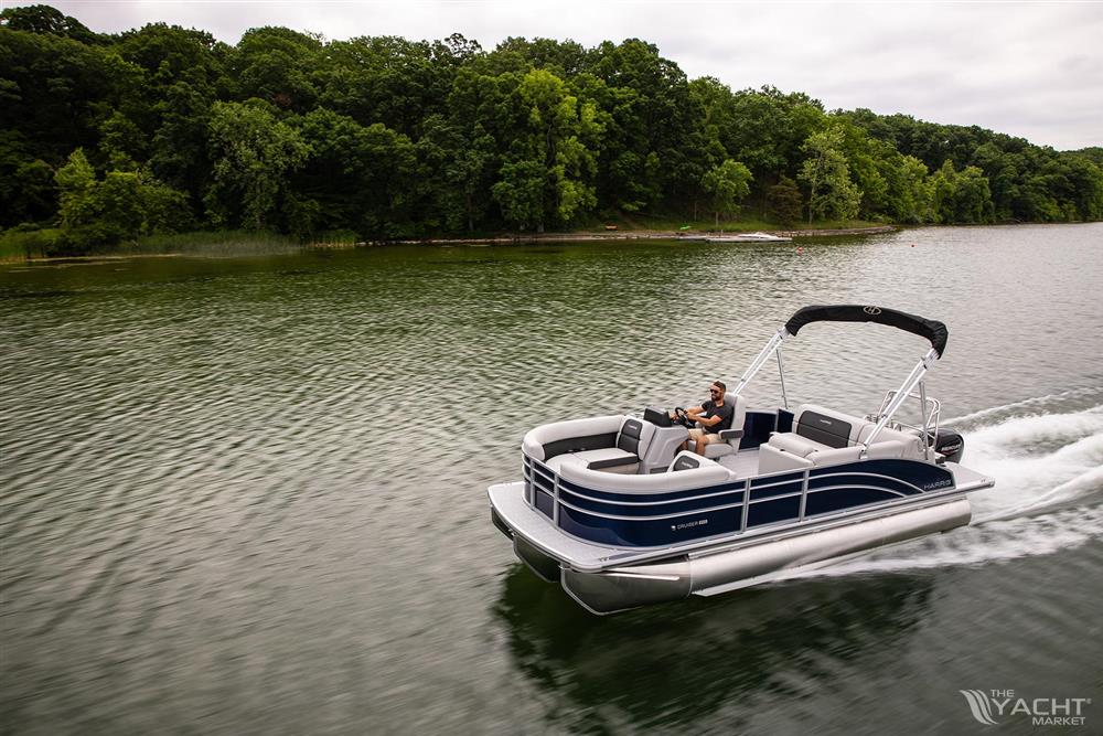 Harris 210 Cruiser - 2023 Harris 210 Cruiser pontoon boat on a lake with lush green trees.