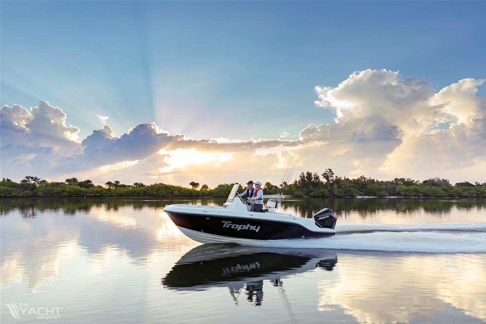 Bayliner Trophy 20 CC - 2023 Bayliner Trophy 20 CC cruising on a serene lake at sunset.