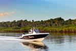 Bayliner Trophy 20 CC - 2023 Bayliner Trophy 20 CC boat cruising on a calm river with lush greenery.