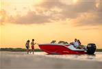 Bayliner Element M19 - 2023 Bayliner Element M19 boat at sunset with people enjoying the water.