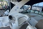 Sea Ray 320 Sundancer - 2006 Sea Ray 320 Sundancer boat interior with seating and control panel.