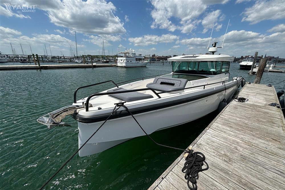 Axopar 37 XC - 2020 Axopar 37 XC boat docked at a marina on a sunny day.