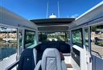 Axopar 37 XC - Interior of 2020 Axopar 37 XC boat with seating and panoramic windows.