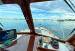 Custom Pemaquid Beach 22 - View from the helm of a 2004 Custom Pemaquid Beach 22 boat on calm waters.