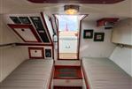 Custom Pemaquid Beach 22 - Interior cabin of 2004 Custom Pemaquid Beach 22 boat with twin beds and control panels.