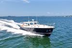MJM 50z - 2017 MJM 50z yacht cruising on open water under clear blue sky.