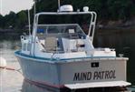 MTI 26-Foot US NAVY Personnel Boat - 1990 MTI 26-Foot US Navy Personnel Boat named Mind Patrol docked on calm water.