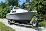 MTI 26-Foot US NAVY Personnel Boat - 1990 MTI 26-Foot US NAVY Personnel Boat on trailer in wooded area.