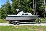 MTI 26-Foot US NAVY Personnel Boat - 1990 MTI 26-Foot US NAVY Personnel Boat on trailer in a wooded area.